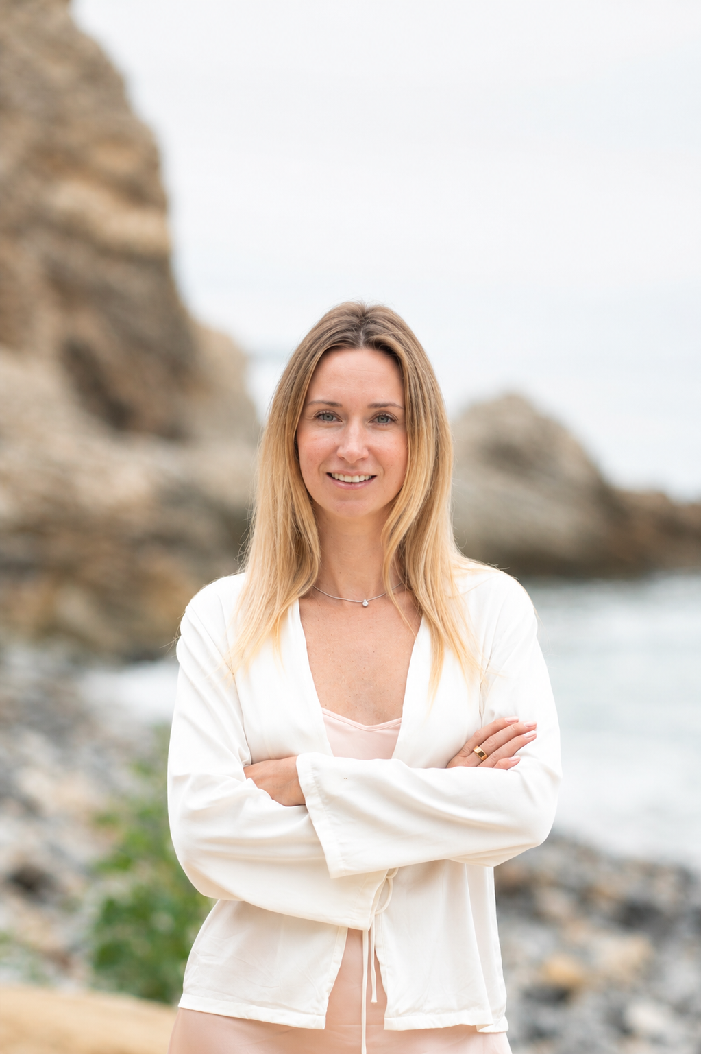 Tetiana on the Pacific coast, sitting on the rocks